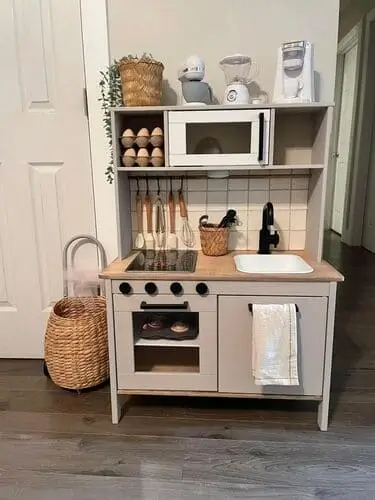 Colorful wooden kitchen play set for young children, featuring pretend cooking tools, a stove, and refrigerator. A perfect, eco-friendly gift that promotes creativity and imaginative play