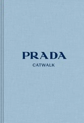 Decorative Prada coffee table book styled on open apartment shelves with other cute decor, perfect for adding a chic and modern touch to your space.