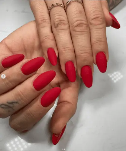 Red velvet nails with a rich, smooth texture for a luxurious and bold Valentine’s Day manicure.