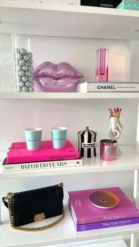 Stylish shelf accessories for cute apartment decor featuring blush pink vases, gold accents, and decorative books.