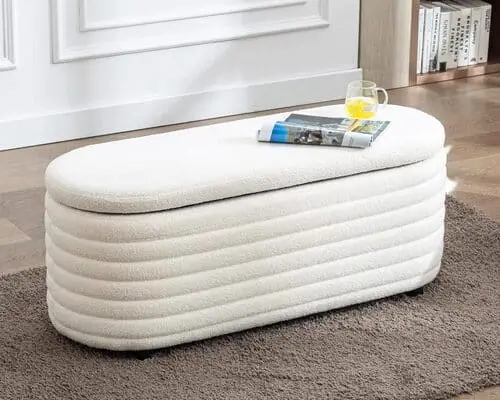 Cute storage bench for the end of the bed, combining functionality and charm for the perfect apartment decor idea.