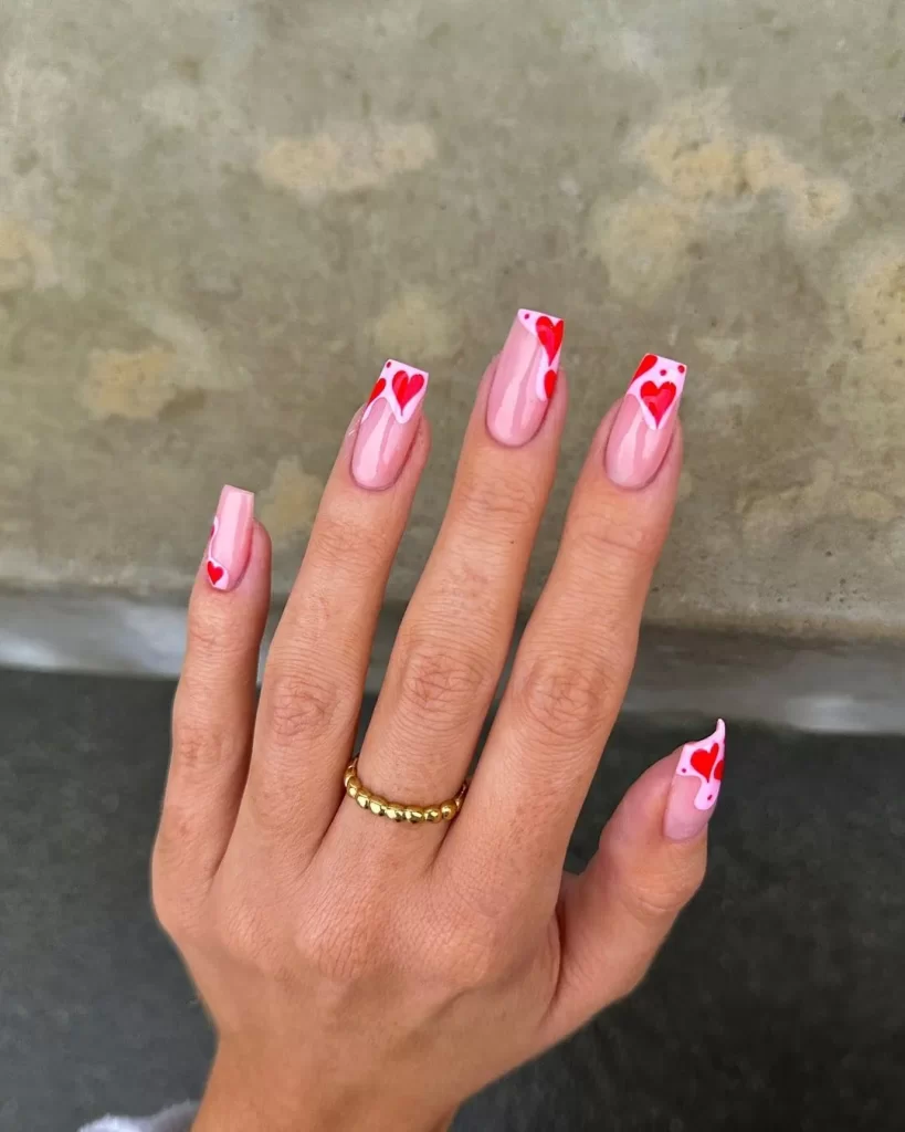 Thick Valentine's french tips with artsy hearts make for a bold and artistic Valentine's nail design