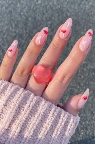 Valentine's Day nail design featuring a heart and lips lollipop for a playful and romantic look. Perfect for adding a sweet and whimsical touch to your manicure.