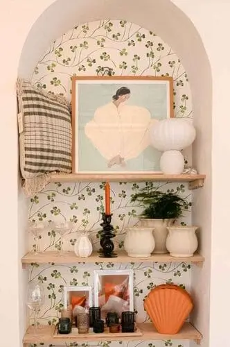 Stylish wallpaper behind shelves creating a bold accent wall, perfect for adding personality and charm to a cute apartment decor setup.