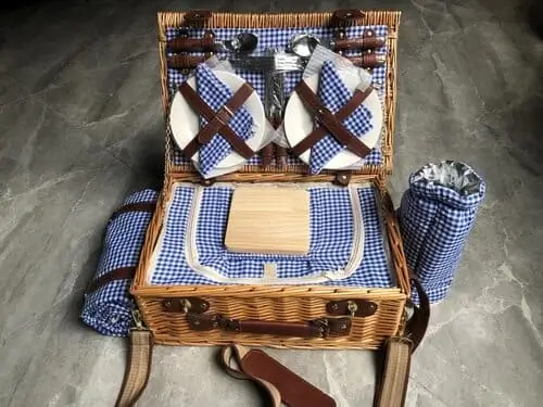 Wicker picnic basket with blue plaid lining and accessories, the ultimate TikTok-inspired gift for aesthetic outdoor vibes.