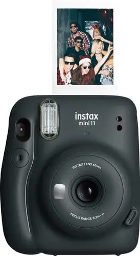 Instant camera printing small polaroid photos, perfect for capturing cottagecore tea parties and baking moments.