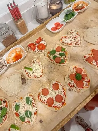 Host a pizza lunch for valentine's day and make heart shaped pizzas with your guests as a fun and delicious activity