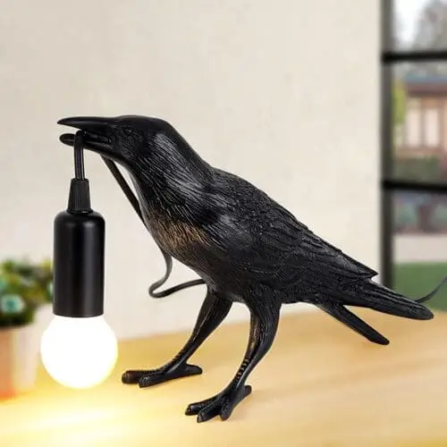 Raven-shaped lamp casting a warm glow, the perfect dark academia gift for moody and unique decor.